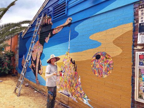 Bryan Snyder painting the Carlsbad Art Wall