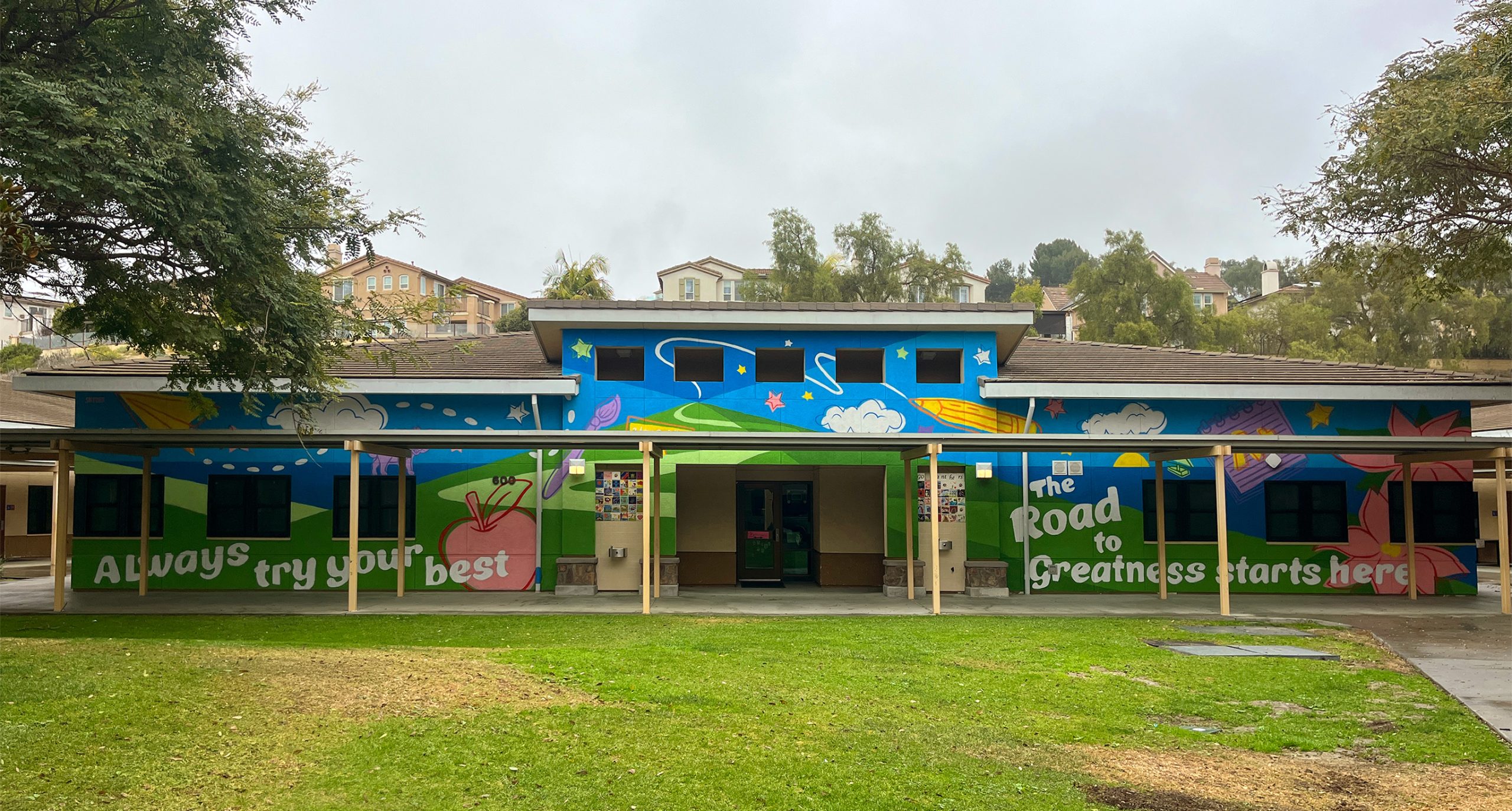 Bryan Snyder paints a mural at Poinsettia Elementary School in Carlsbad